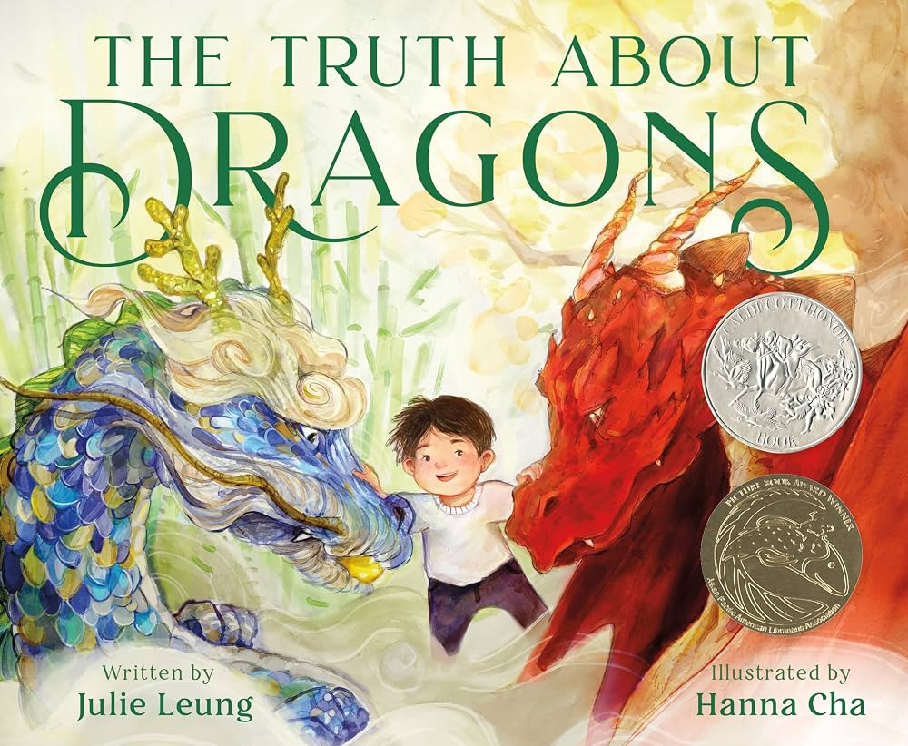 The Truth About Dragons,' a Caldecott Honor and Pura Belpré Award winner, written by Julie Leung and illustrated by Hanna Cha. A smiling boy stands between a blue Eastern-style dragon and a fierce red Western-style dragon.